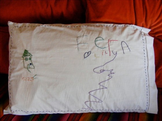Lily drew in pencil on the pillow case and I carefully embroidered the artwork. Age 4